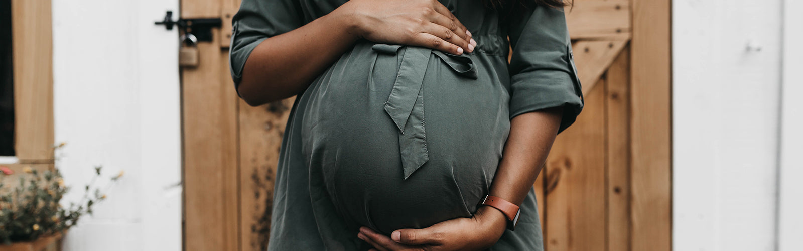 Pregnant mother holding her stomach: A hospital bag checklist for mom & baby