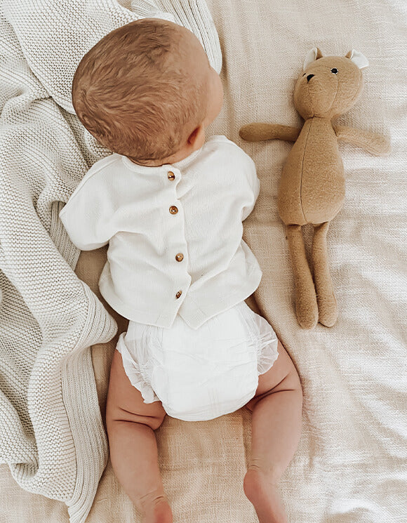 Baby wearing eco friendly Believe Diaper with teddy bear